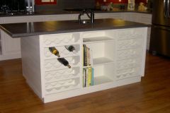Island-with-wine-racks-on-each-side-of-a-bookcase
